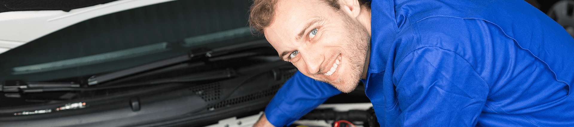 Auto Mechanic Working on a Car
