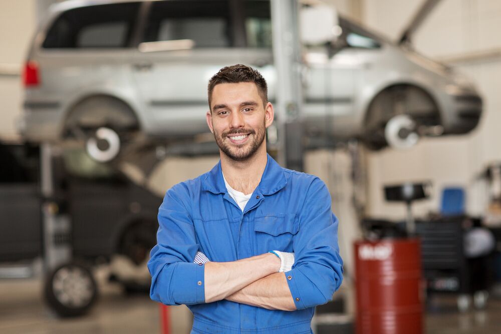 happy auto mechanic in auto shop